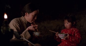 Movie still from “The Joy Luck Club” (1993), directed by Wayne Wang – A woman and a child eating food from a bowl; Medium shot, Over the shoulder angle