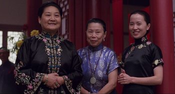 Movie still from “The Joy Luck Club” (1993), directed by Wayne Wang – A group of women standing next to each other in front of a red curtain; Medium shot, Low angle
