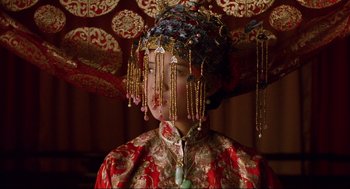 Movie still from “The Joy Luck Club” (1993), directed by Wayne Wang – A woman in a red dress with a gold headpiece; Close Up shot, Low angle
