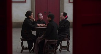 Movie still from “The Joy Luck Club” (1993), directed by Wayne Wang – A group of people sitting around a table; Wide shot, High angle