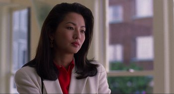 Movie still from “The Joy Luck Club” (1993), directed by Wayne Wang – A woman in a white jacket and a red tie; Close Up shot, Low angle