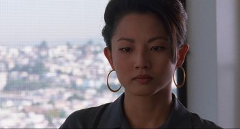 Movie still from “The Joy Luck Club” (1993), directed by Wayne Wang – A person wearing a jacket and earrings; Close Up shot, Over the shoulder angle