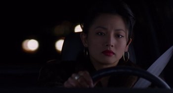 Movie still from “The Joy Luck Club” (1993), directed by Wayne Wang – A woman sitting in the driver's seat of a car at night; Close Up shot, High angle
