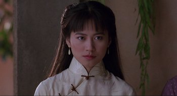 Movie still from “The Joy Luck Club” (1993), directed by Wayne Wang – A woman with long black hair wearing a white shirt; Close Up shot, Low angle