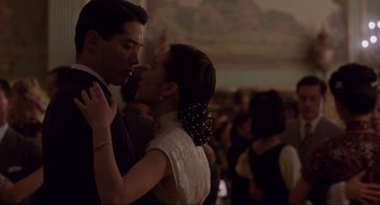 Movie still from “The Joy Luck Club” (1993), directed by Wayne Wang – A man and a woman are kissing in front of a crowd; Close Up shot, Low angle
