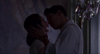 Movie still from “The Joy Luck Club” (1993), directed by Wayne Wang – A man and a woman kissing in a dark room; Close Up shot, Low angle