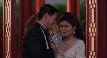 Movie still from “The Joy Luck Club” (1993), directed by Wayne Wang – A man and a woman standing next to each other in front of a microphone; Medium shot, Over the shoulder angle