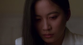 Movie still from “The Joy Luck Club” (1993), directed by Wayne Wang – A person with long black hair; Close Up shot, Low angle