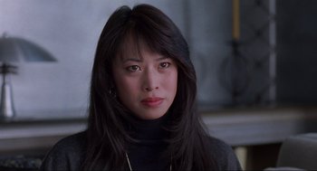 Movie still from “The Joy Luck Club” (1993), directed by Wayne Wang – A person with long black hair; Close Up shot, Over the shoulder angle