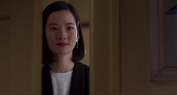 Movie still from “The Joy Luck Club” (1993), directed by Wayne Wang – A young woman with dark hair wearing a white shirt and a black jacket; Close Up shot, Over the shoulder angle