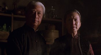 Movie still from “The Joy Luck Club” (1993), directed by Wayne Wang – An older man standing next to an older woman; Close Up shot, Low angle
