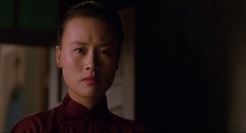 Movie still from “The Joy Luck Club” (1993), directed by Wayne Wang – A woman in a red shirt is looking at the camera; Close Up shot, Low angle