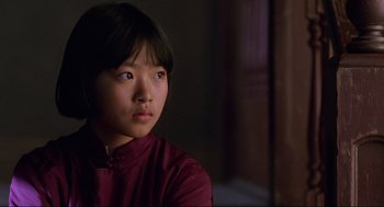 Movie still from “The Joy Luck Club” (1993), directed by Wayne Wang – A young asian girl in a red shirt looking off to the side; Close Up shot, Low angle