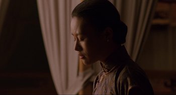 Movie still from “The Joy Luck Club” (1993), directed by Wayne Wang – A young woman is looking down at her face; Close Up shot, Low angle