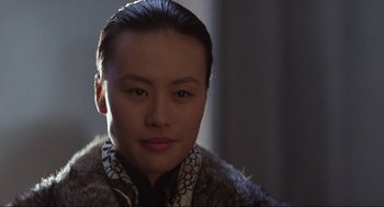 Movie still from “The Joy Luck Club” (1993), directed by Wayne Wang – A young woman wearing a fur coat with a scarf around her neck; Close Up shot, Over the shoulder angle