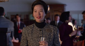 Movie still from “The Joy Luck Club” (1993), directed by Wayne Wang – A woman holding a glass of wine in her hand; Close Up shot, Over the shoulder angle