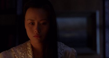 Movie still from “The Joy Luck Club” (1993), directed by Wayne Wang – A woman with long black hair is looking at the camera; Close Up shot, Over the shoulder angle