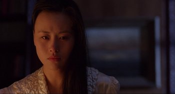 Movie still from “The Joy Luck Club” (1993), directed by Wayne Wang – A woman with long black hair is looking at the camera; Close Up shot, Over the shoulder angle