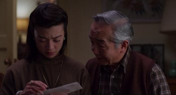 Movie still from “The Joy Luck Club” (1993), directed by Wayne Wang – An older man and a younger woman looking at a piece of paper; Close Up shot, Over the shoulder angle