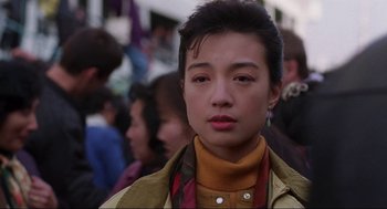 Movie still from “The Joy Luck Club” (1993), directed by Wayne Wang – A woman with a yellow jacket and a yellow scarf; Close Up shot, Low angle