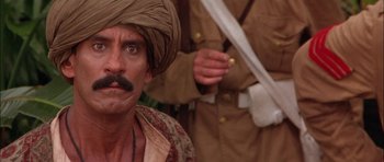 Movie still from “The Jungle Book” (1994), directed by Stephen Sommers – A man with a mustache wearing a turban; Close Up shot, Low angle
