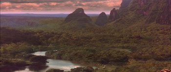 Movie still from “The Jungle Book” (1994), directed by Stephen Sommers – A view of mountains and a lake from above; Extreme Wide shot, High angle