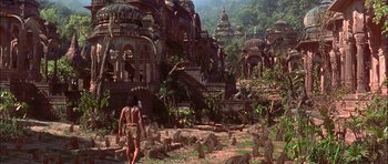 Movie still from “The Jungle Book” (1994), directed by Stephen Sommers – An image of a man standing in the middle of a jungle; Extreme Wide shot, High angle