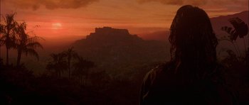 Movie still from “The Jungle Book” (1994), directed by Stephen Sommers – A view of a mountain at sunset from a hill top; Close Up shot, Over the shoulder angle