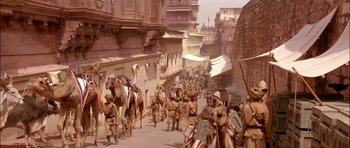 Movie still from “The Jungle Book” (1994), directed by Stephen Sommers – An image of an old picture of people walking down the street; Extreme Wide shot, High angle