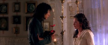 Movie still from “The Jungle Book” (1994), directed by Stephen Sommers – A man and a woman standing in front of a lamp; Medium shot, Over the shoulder angle