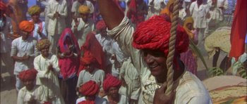 Movie still from “The Jungle Book” (1994), directed by Stephen Sommers – A group of people in a crowd wearing red hats; Close Up shot, High angle