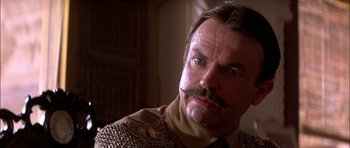 Movie still from “The Jungle Book” (1994), directed by Stephen Sommers – A person with a mustache; Close Up shot, Low angle