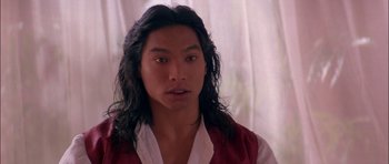 Movie still from “The Jungle Book” (1994), directed by Stephen Sommers – A person with long black hair; Close Up shot, Over the shoulder angle