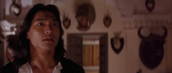 Movie still from “The Jungle Book” (1994), directed by Stephen Sommers – A person standing in a room with a lot of animal heads on the wall; Close Up shot, Over the shoulder angle