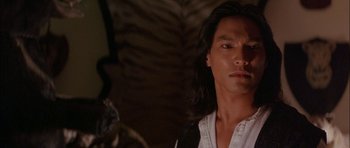 Movie still from “The Jungle Book” (1994), directed by Stephen Sommers – A person with long black hair; Close Up shot, Over the shoulder angle