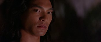 Movie still from “The Jungle Book” (1994), directed by Stephen Sommers – A person with long black hair; Close Up shot, Over the shoulder angle