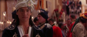 Movie still from “The Jungle Book” (1994), directed by Stephen Sommers – A woman in a turban and a man in a suit; Close Up shot, Over the shoulder angle