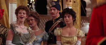 Movie still from “The Jungle Book” (1994), directed by Stephen Sommers – A man and two women dressed up in costumes; Medium shot, Over the shoulder angle