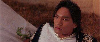 Movie still from “The Jungle Book” (1994), directed by Stephen Sommers – A person with long black hair; Close Up shot, High angle