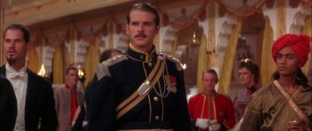 Movie still from “The Jungle Book” (1994), directed by Stephen Sommers – A man in a military uniform standing in front of other men; Medium shot, Low angle