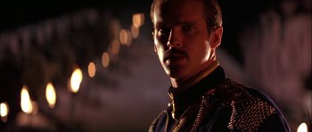 Movie still from “The Jungle Book” (1994), directed by Stephen Sommers – A person wearing a uniform; Close Up shot, Over the shoulder angle