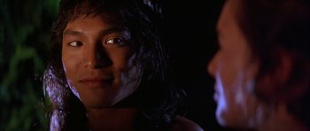Movie still from “The Jungle Book” (1994), directed by Stephen Sommers – A person with long hair is looking at the camera; Close Up shot, Over the shoulder angle