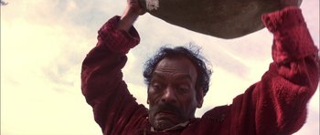 Movie still from “The Jungle Book” (1994), directed by Stephen Sommers – An old man holding on to a large object; Close Up shot, Low angle
