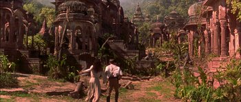 Movie still from “The Jungle Book” (1994), directed by Stephen Sommers – A man and a woman are walking through a forest; Extreme Wide shot, High angle