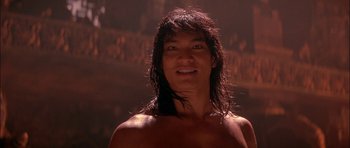 Movie still from “The Jungle Book” (1994), directed by Stephen Sommers – A man with long hair and no shirt is smiling for the camera; Close Up shot, Low angle
