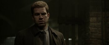 Movie still from “Department Q: The Keeper of Lost Causes” (2013), directed by Mikkel Nørgaard – A person wearing a suit and tie; Close Up shot, Over the shoulder angle