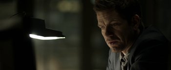 Movie still from “Department Q: The Keeper of Lost Causes” (2013), directed by Mikkel Nørgaard – A person looking at a light; Close Up shot, Over the shoulder angle