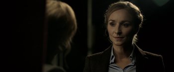 Movie still from “Department Q: The Keeper of Lost Causes” (2013), directed by Mikkel Nørgaard – A woman in a brown jacket is talking to another woman; Close Up shot, Over the shoulder angle