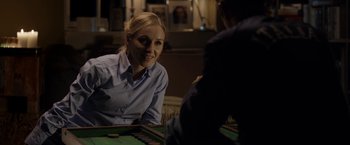 Movie still from “Department Q: The Keeper of Lost Causes” (2013), directed by Mikkel Nørgaard – A woman sitting in front of a man playing a game of backgammon; Medium shot, Over the shoulder angle