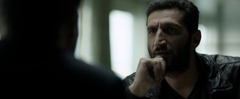 Movie still from “Department Q: The Keeper of Lost Causes” (2013), directed by Mikkel Nørgaard – A man with a goatee is looking at himself in the mirror; Close Up shot, Over the shoulder angle